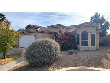 Single-story home with attached two-car garage and landscaped front yard at 13383 W Ironwood St, Surprise, AZ 85374