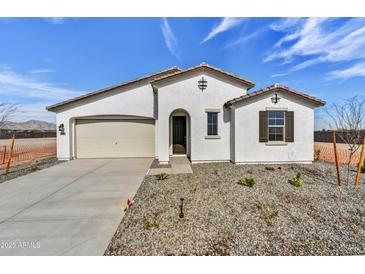 Charming single-Gathering home featuring a two-car garage and low-maintenance desert landscaping at 18950 W Stella Ave, Waddell, AZ 85355