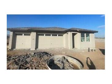 New construction home with attached two-car garage and desert landscaping at 19008 W Stella Ave, Waddell, AZ 85355