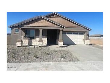 One-story home with a two-car garage and desert landscaping at 19026 W Stella Ave, Waddell, AZ 85355