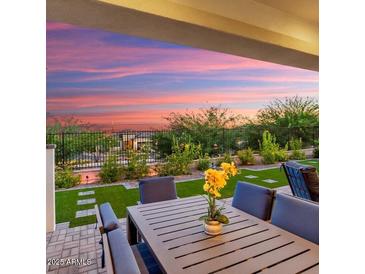 Relaxing backyard patio with seating area and artificial turf at 20363 W Coolidge St, Buckeye, AZ 85396