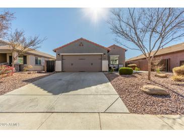 Single-story home with a two-car garage and desert landscaping at 2185 E Hazeltine Way, Gilbert, AZ 85298