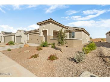 Single-story home with desert landscaping and two-car garage at 26448 W Kimberly Way, Buckeye, AZ 85396