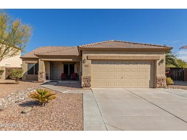 Single-story home with a two-car garage and desert landscaping at 2878 N Paisley Ave, Casa Grande, AZ 85122