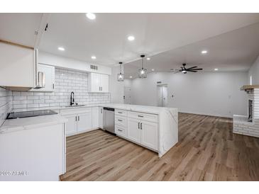 Modern white kitchen with quartz countertops and stainless steel appliances at 619 N Norfolk --, Mesa, AZ 85205