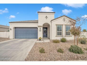 Single-story home with a two-car garage and landscaped front yard at 8448 W Candlewood Way, Florence, AZ 85132