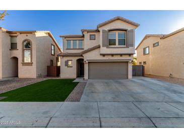 Two-story house with a gray garage door and artificial turf at 9823 E Escondido Ave, Mesa, AZ 85208