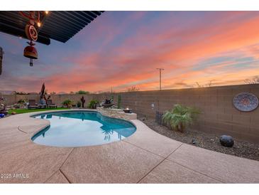 Inviting kidney-shaped pool with a tranquil water feature at 24280 N 164Th Dr, Surprise, AZ 85387