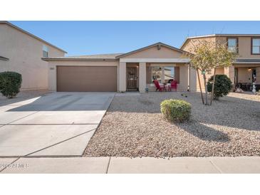 Inviting curb appeal featuring a two-car garage and well-manicured front yard at 307 E Impala Ct, Casa Grande, AZ 85122