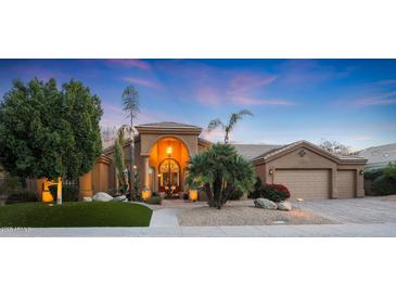 Beautiful desert home with a landscaped front yard, large garage, and inviting entryway at 9353 N 113Th Way, Scottsdale, AZ 85259