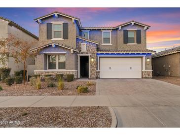 Two-story house with white garage door and landscaping at 9540 E Spiral Ave, Mesa, AZ 85212