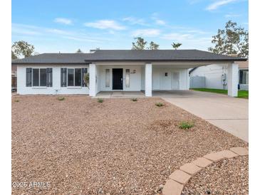 Charming single-story home with carport and well-maintained landscaping at 1015 W Minton Dr, Tempe, AZ 85282