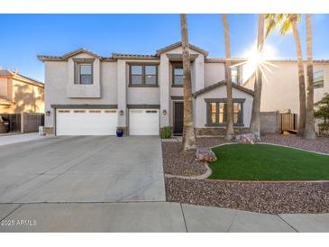 Two-story house with three-car garage and landscaped front yard at 10617 W Adela Dr, Peoria, AZ 85383