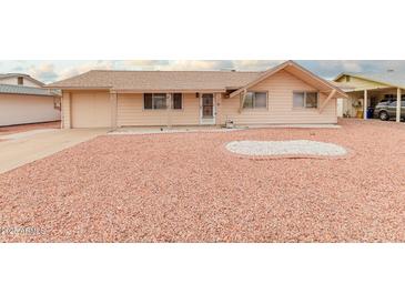 Ranch style home with a large front yard and a two-car garage at 11440 N Hagen Dr, Sun City, AZ 85351