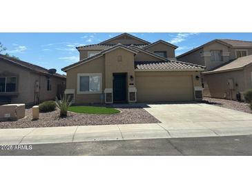 Two-story house with a two-car garage and landscaped front yard at 11621 W Cheryl Dr, Youngtown, AZ 85363