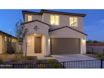 Two-story house with brown garage door and landscaping at 13183 N 145Th Ln, Surprise, AZ 85379