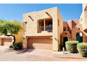 Front view of a two-story stucco home with a two-car garage and desert landscaping at 13227 N Mimosa Dr # 117, Fountain Hills, AZ 85268