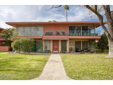 Mid-century modern building with two levels, balconies, and a manicured lawn at 148 E Coronado Rd # 45, Phoenix, AZ 85004