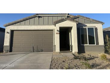 New single-story home with attached two-car garage and desert landscaping at 18070 W Cielo Grande Ave, Surprise, AZ 85387