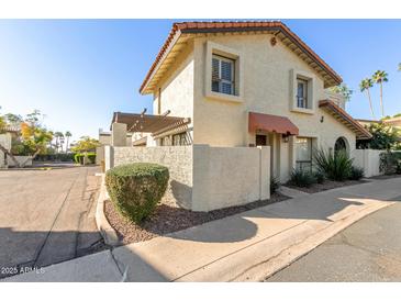 Cute two-story stucco home with a landscaped yard and walkway at 1817 E Hayward Ave # 3, Phoenix, AZ 85020