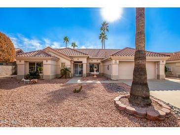 Single-story home with tile roof, desert landscaping, and two-car garage at 19619 N White Rock Dr, Sun City West, AZ 85375