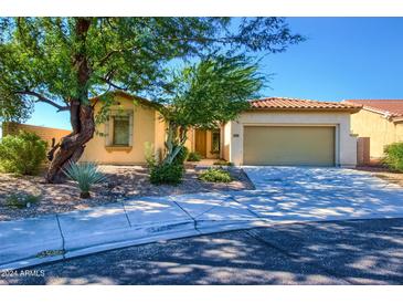 Single-story home with a two-car garage and desert landscaping at 29302 N 126Th Ln, Peoria, AZ 85383