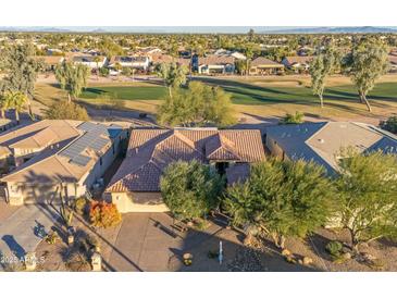 Aerial view of single-story home with solar panels, near golf course at 3755 N 161St Ave, Goodyear, AZ 85395