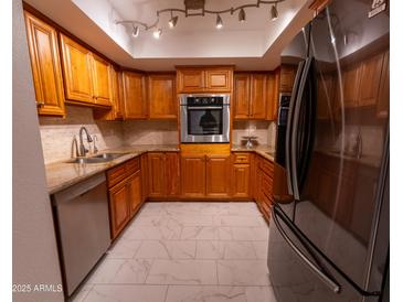 Modern kitchen with granite countertops and stainless steel appliances at 4200 N Miller Rd # 121, Scottsdale, AZ 85251