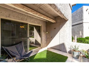 Private patio with seating and artificial turf at 4444 E Paradise Village N Pkwy # 107, Phoenix, AZ 85032