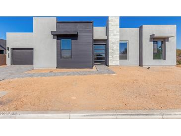 Modern home exterior boasts clean lines and neutral color palette at 5748 E Moura Dr, Cave Creek, AZ 85331