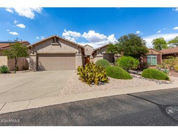 Single-story home with desert landscaping and two-car garage at 10902 E Silver Mine Rd, Gold Canyon, AZ 85118
