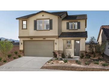 Charming two-story home with a two-car garage, neutral stucco, stone accents, and a well-manicured front yard at 18245 W Papago St, Goodyear, AZ 85338