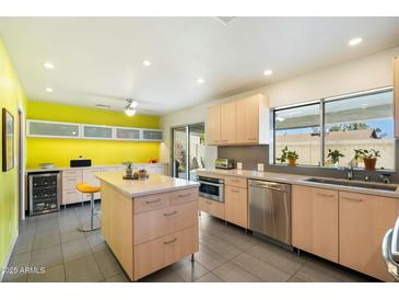 Modern kitchen featuring light wood cabinets, a large island, and stainless steel appliances at 2856 E Cochise Rd, Phoenix, AZ 85028