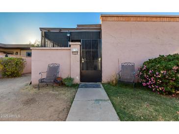 Tan stucco house with a gated entrance and small front yard at 5984 W Augusta Ave, Glendale, AZ 85301