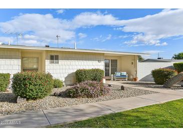 Inviting exterior with well-manicured landscaping and walkway at 10529 W Palmeras Dr, Sun City, AZ 85373