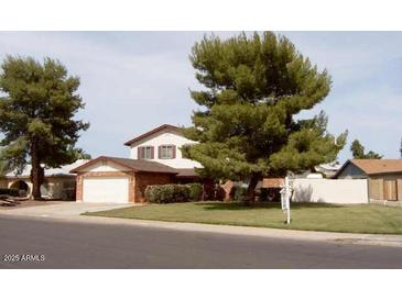 Two-story house with attached garage and mature landscaping at 11051 N 53Rd Ave, Glendale, AZ 85304