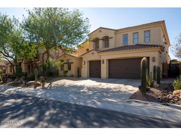 Two-story house with three-car garage and desert landscaping at 13347 W Via Caballo Blanco --, Peoria, AZ 85383