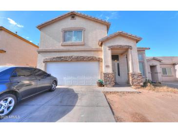 Two-story house with attached garage and landscaping at 1406 S Navajo Ln, Coolidge, AZ 85128