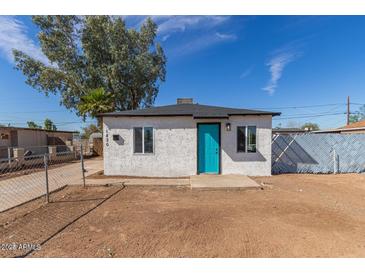 Newly renovated single story home with teal door at 1830 N 37Th Dr, Phoenix, AZ 85009