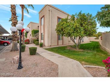 Attractive exterior of condo building with landscaping and walkway at 205 N 74Th St # 159, Mesa, AZ 85207