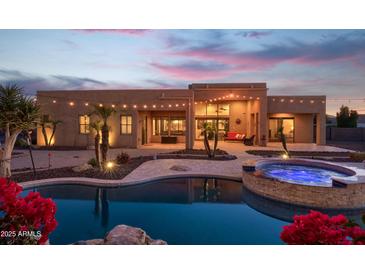 Stunning desert home with pool and spa at dusk at 39005 N 11Th Ave, Phoenix, AZ 85086