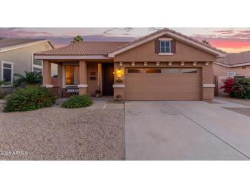 Single-story home with a two-car garage and desert landscaping at 6931 W Blackhawk Dr, Glendale, AZ 85308