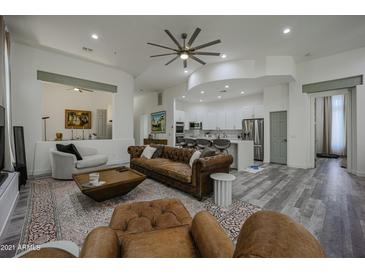 Spacious living room with leather sofas, a large TV, and an open floor plan at 8136 E Beardsley Rd, Scottsdale, AZ 85255