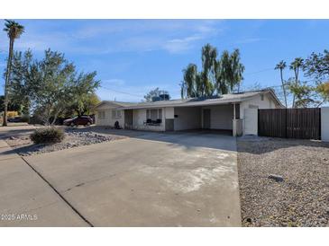 Ranch style home with carport and mature landscaping at 829 E 9Th Pl, Mesa, AZ 85203