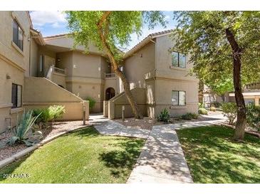Well-maintained condo building with attractive landscaping and walkways at 15225 N 100Th St # 2187, Scottsdale, AZ 85260