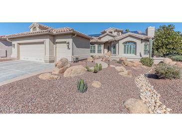 Single-story home with desert landscaping, large garage, and solar panels at 15938 W Mulberry Dr, Goodyear, AZ 85395