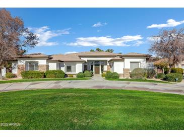 Single-story home with stone accents and a manicured lawn at 2536 E Wood Pl, Chandler, AZ 85249