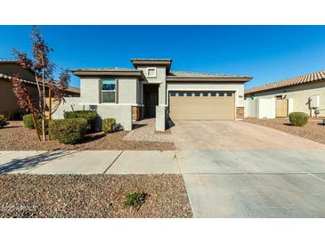 Single-story home with a two-car garage and landscaped front yard at 40108 W Crane Dr, Maricopa, AZ 85138