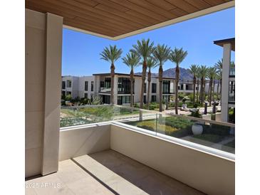 Enjoy serene balcony views of lush landscaping and palm trees in this modern condo at 6587 N Palmeraie Blvd # 2022, Paradise Valley, AZ 85253