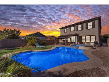 Stunning backyard oasis featuring a sparkling pool, spa, and expansive patio at 10307 E Nopal Ave, Mesa, AZ 85209